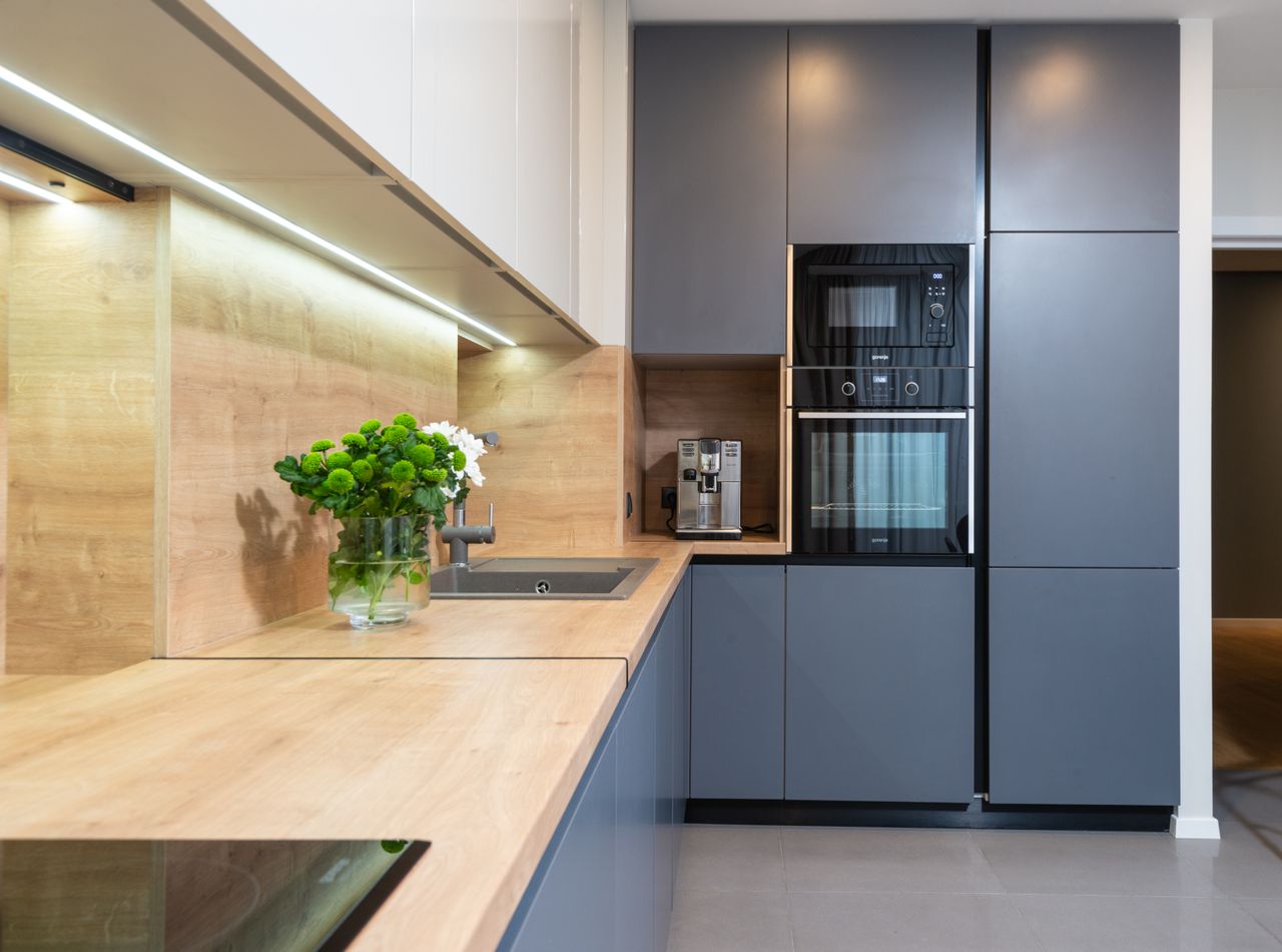 Crafting Captivating Headlines: Your awesome post title goes here Creative design of kitchen with flowers in vase on table against coffeemaker and oven built in cupboard at home